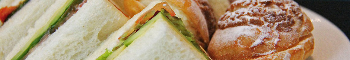 Eating Burger Sandwich Cheesesteak at Rondo's Submarine Sandwiches restaurant in South Boston, MA.